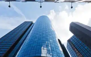 How professional service firms measure profitability beyond billable hours, paired with an image of tall skyscraper buildings.