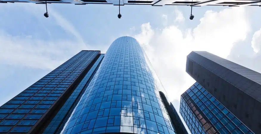 How professional service firms measure profitability beyond billable hours, paired with an image of tall skyscraper buildings.